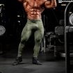 Bodybuilder wearing compression pants in army green color.